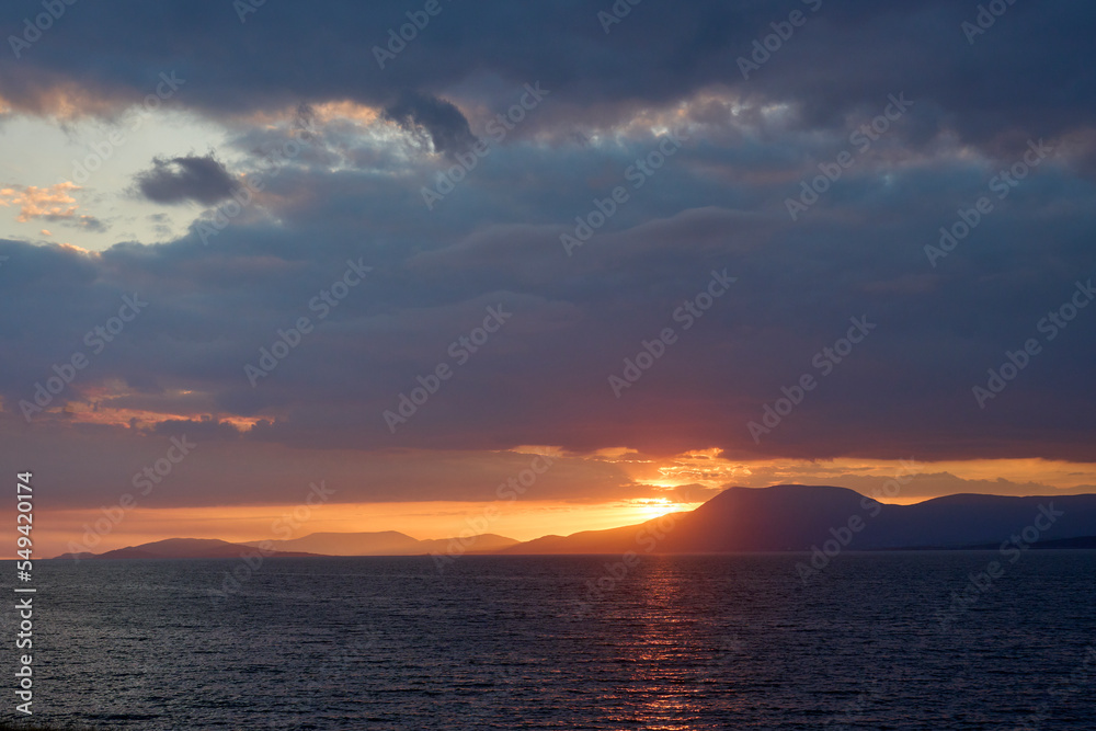 sunset with dramatic cloud sky at Clifton beach in county Galway, western part of the Republic of Ireland sunset with dramatic cloud sky at Clifton beach in county Galway, western part of the Republic of Ireland
