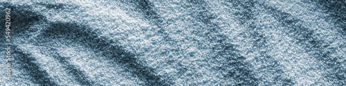 Banner horizontal sand blue light background format 4 1 with waves of sand macro photography