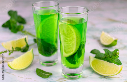 Delicious mint liquor with lime and green mint leaves, closeup 