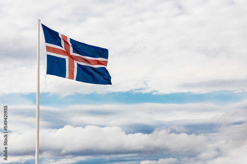 Iceland flag waving with wind against blue sky