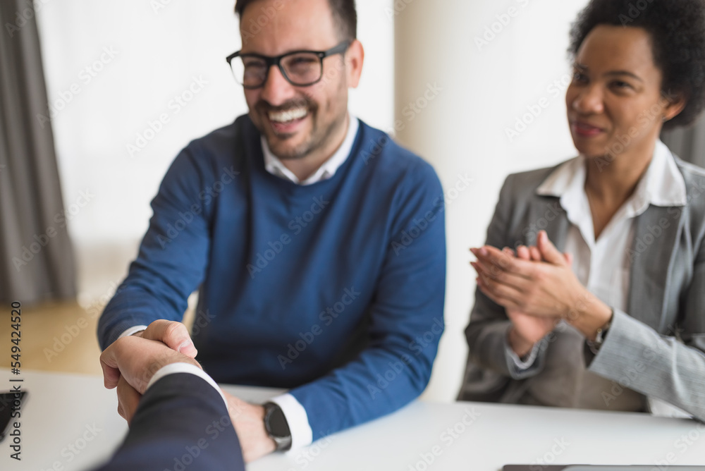 Fototapeta premium Two diverse partners, happy for their business deal with a client.