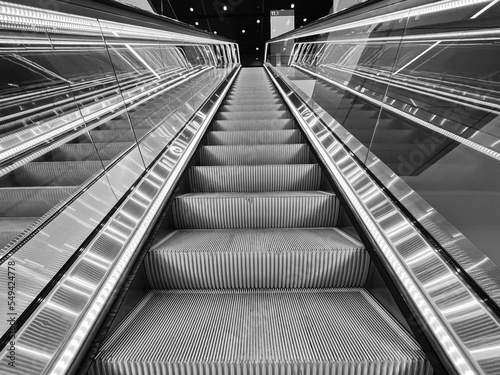 Moving up in a escalator with glass sides in a modern building © nvphoto