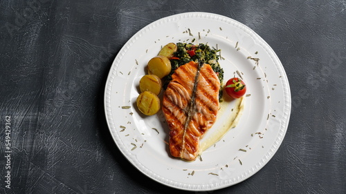 Tableau sur toile grilled fish dish with sauce on black background