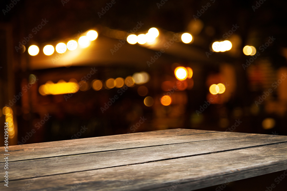 Wooden table top on blurred cafe showcase with light bulb. Background ...