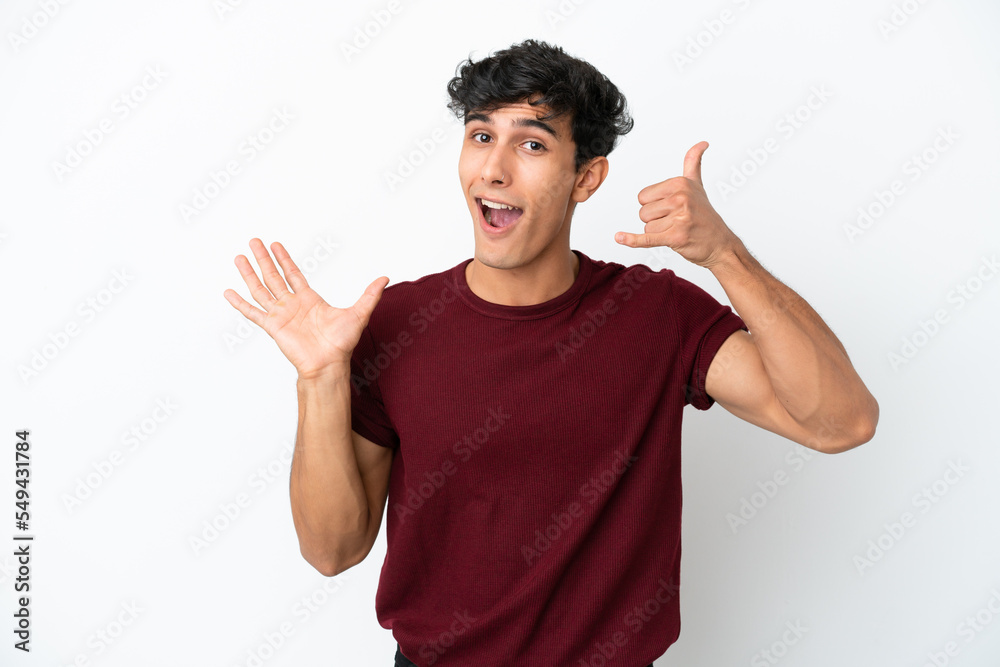 Young Argentinian man isolated on white background making phone gesture and doubting Young Argentinian man isolated on white background making phone gesture and doubting
