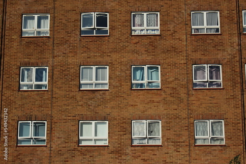 White and clear modern windows on a brick apartment wall in London, UK. Modern urban architecture wallpaper or background