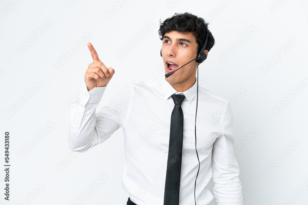Telemarketer man working with a headset isolated on white background pointing away Telemarketer man working with a headset isolated on white background pointing away