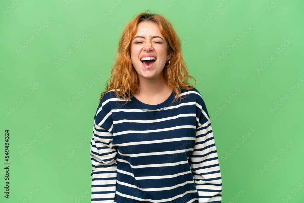 Young caucasian woman isolated on green screen chroma key background shouting to the front with mouth wide open Young caucasian woman isolated on green screen chroma key background shouting to the front with mouth wide open