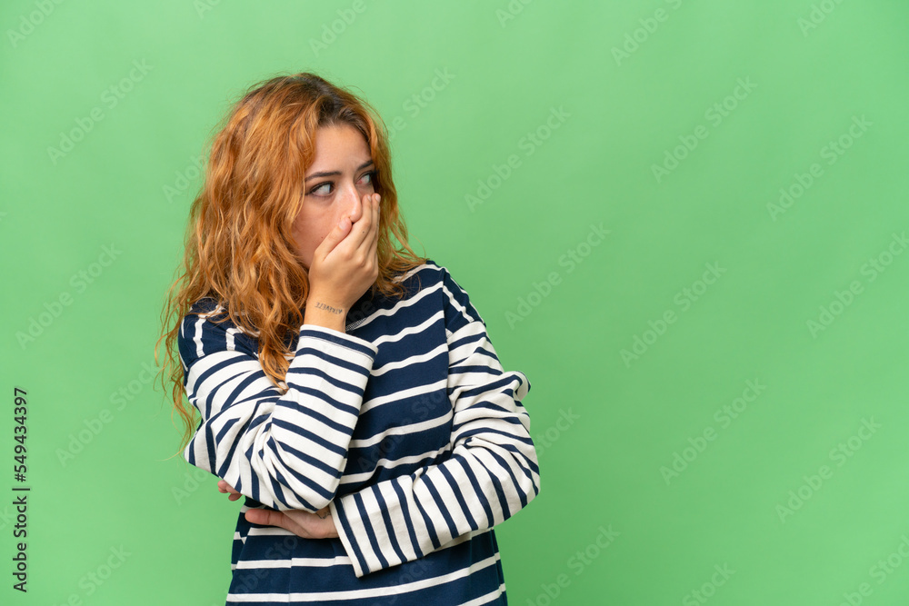 Young caucasian woman isolated on green screen chroma key background doing surprise gesture while looking to the side Young caucasian woman isolated on green screen chroma key background doing surprise gesture while looking to the side