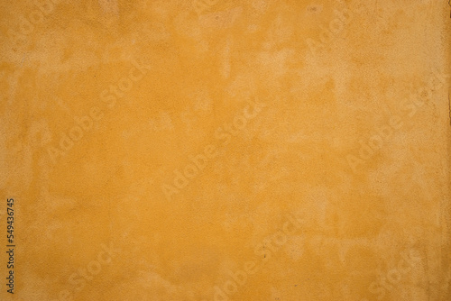 Vintage house plastered beige painted wall closeup as colored background