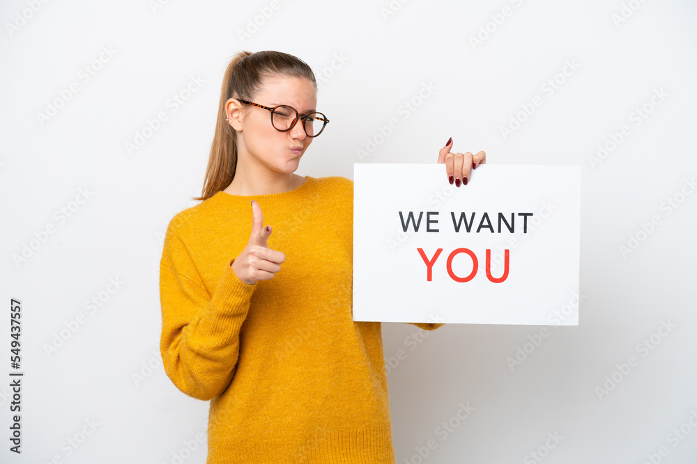 Young caucasian woman isolated on white background holding We Want You board and pointing to the front Young caucasian woman isolated on white background holding We Want You board and pointing to the front