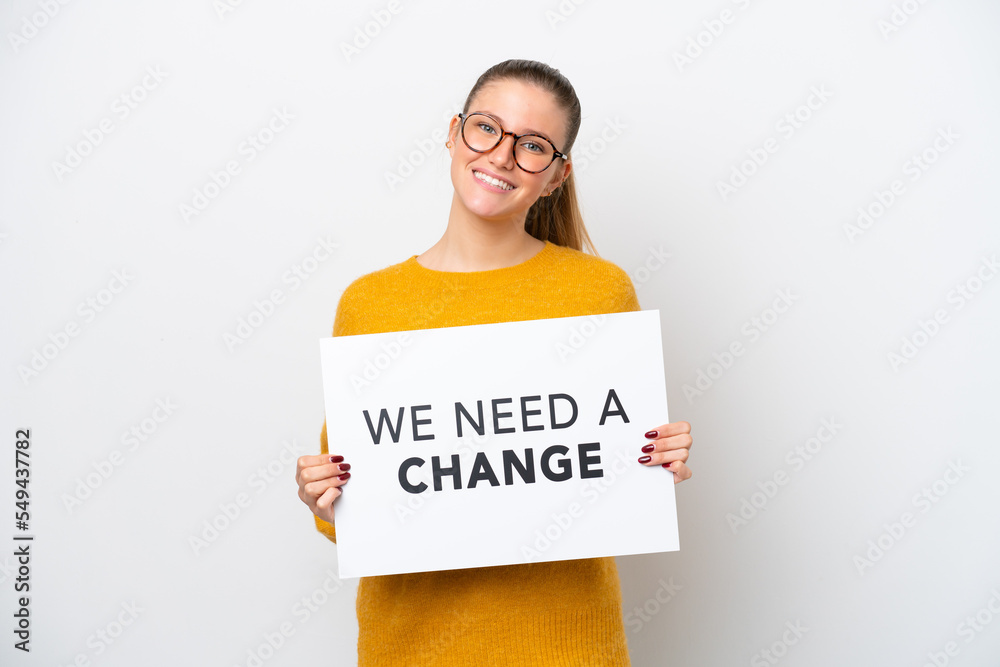 Young caucasian woman isolated on white background holding a placard with text We Need a Change with happy expression Young caucasian woman isolated on white background holding a placard with text We Need a Change with happy expression