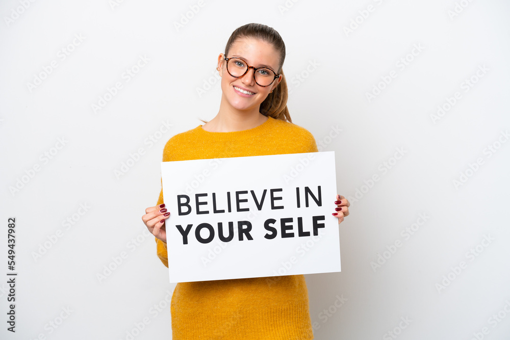 Young caucasian woman isolated on white background holding a placard with text Believe In Your Self with happy expression Young caucasian woman isolated on white background holding a placard with text Believe In Your Self with happy expression