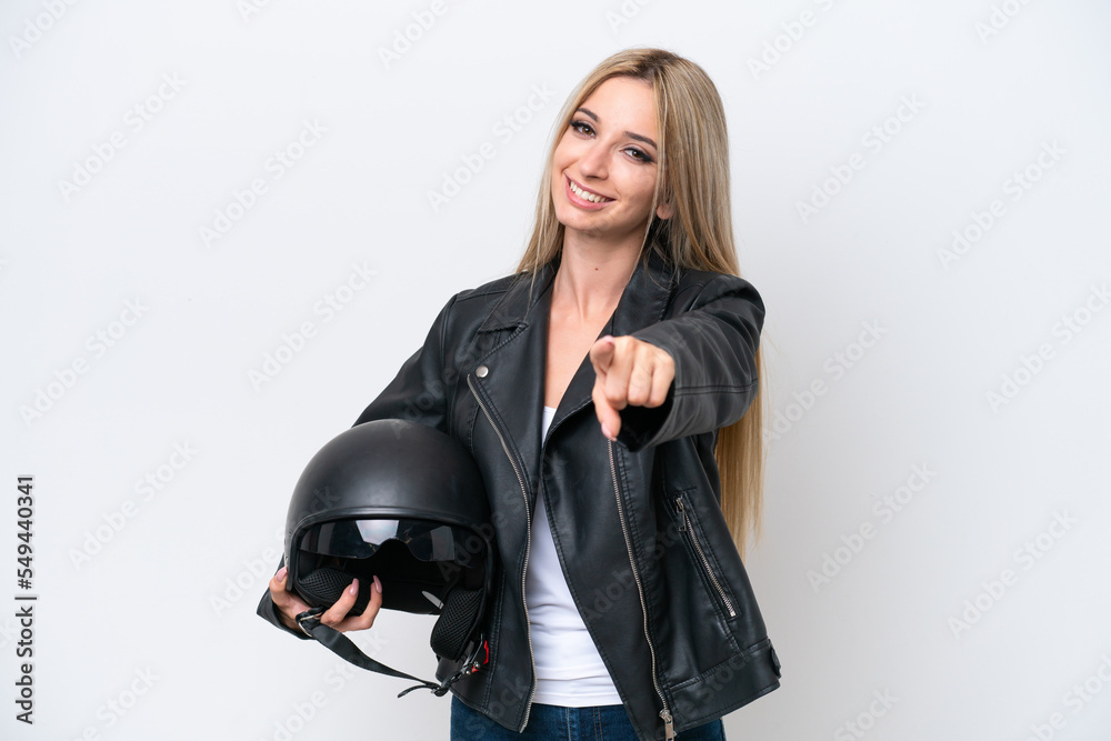 Pretty blonde woman with a motorcycle helmet isolated on white background pointing front with happy expression Pretty blonde woman with a motorcycle helmet isolated on white background pointing front with happy expression