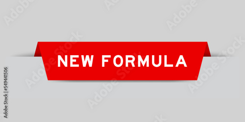 Red color inserted label with word new formula on gray background