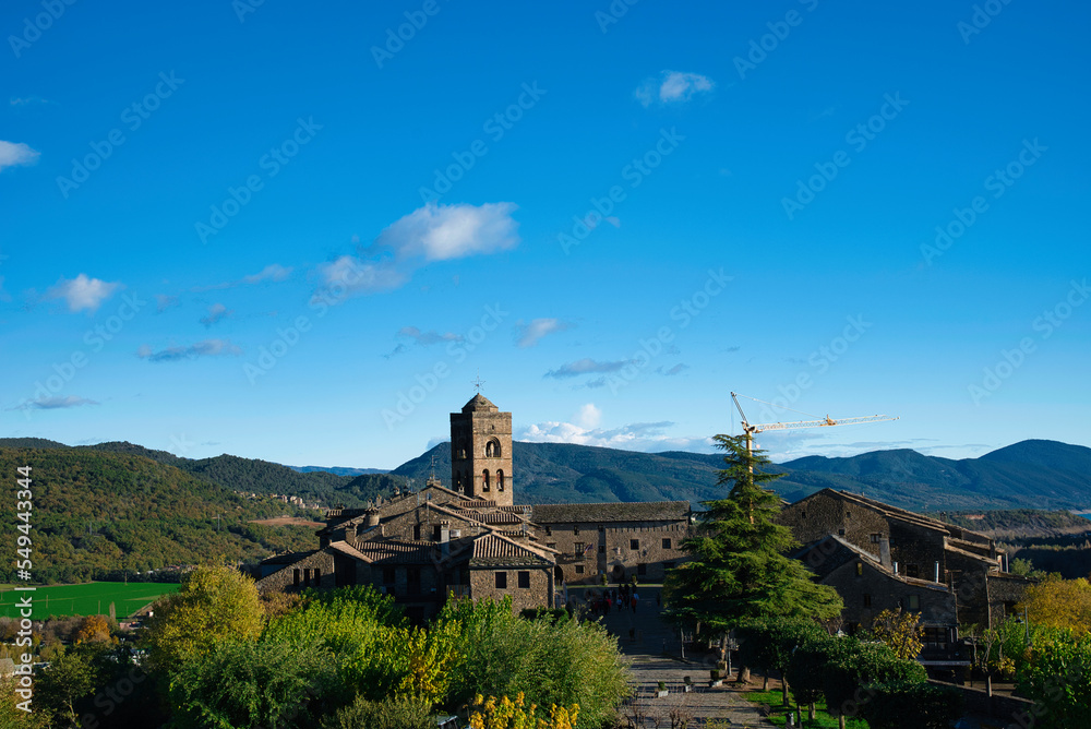Ainsa Sorbrarbe medieval village in the Pyrenees with beautiful stone houses and the slender church tower, Huesca, Spain