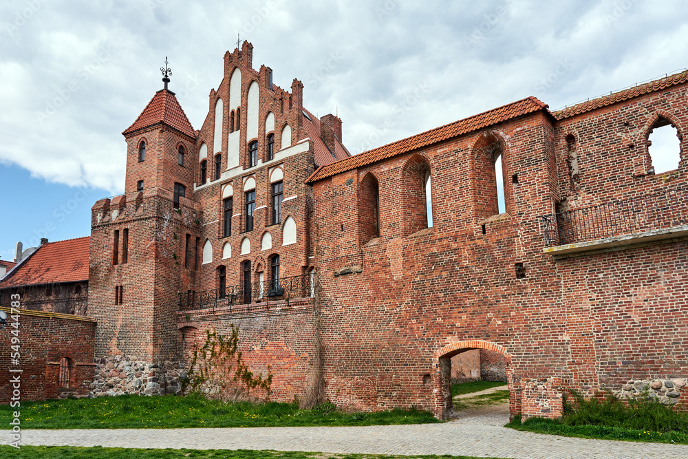 medieval brick walls and a historic tenement house in the city of Torun