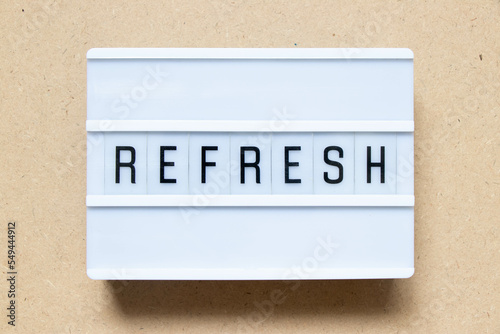 Lightbox with word refresh on wood background