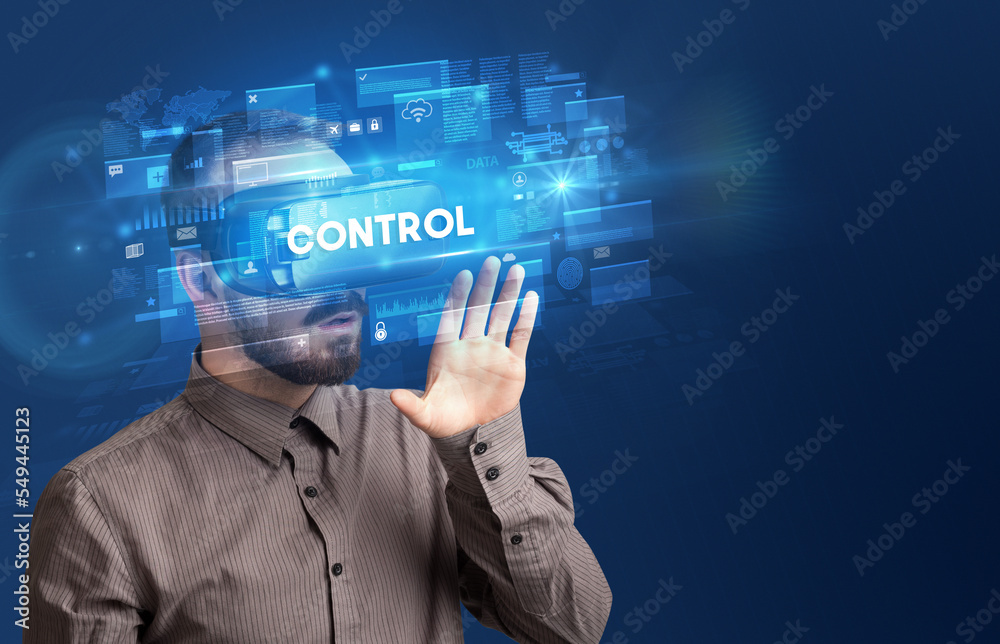 Businessman looking through Virtual Reality glasses Businessman looking through Virtual Reality glasses