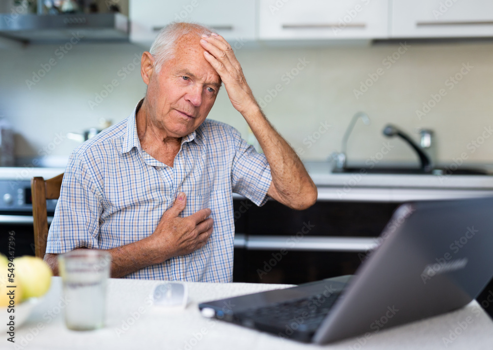Old man having online medical consultation through internet