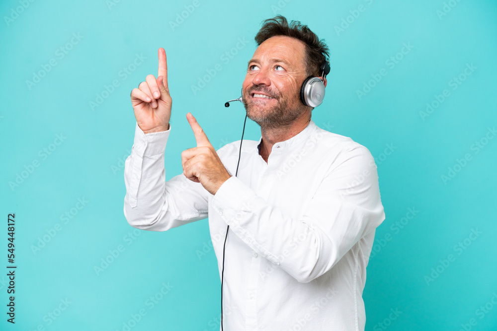 Telemarketer caucasian man working with a headset isolated on blue background pointing with the index finger a great idea Telemarketer caucasian man working with a headset isolated on blue background pointing with the index finger a great idea