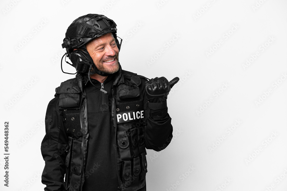 Middle age SWAT man isolated on white background pointing to the side to present a product Middle age SWAT man isolated on white background pointing to the side to present a product