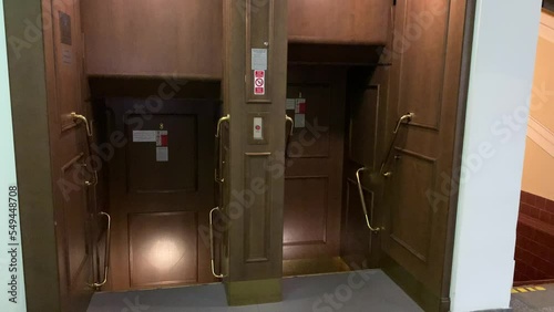 Motion of wooden vintage open, no door paternoster lift at Prague's New city hall.  Tourists very often comes to see this rare elevator technology. Prague, Czech Republic photo