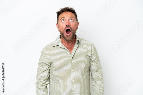 Middle age caucasian man isolated on white background looking up and with surprised expression