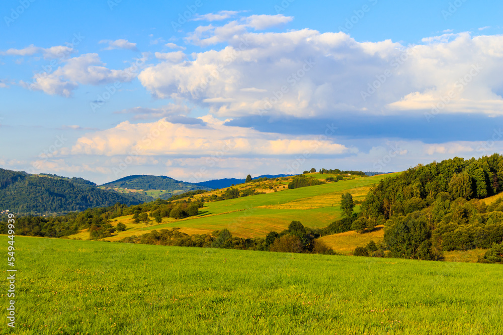 Green hills of Beskidy Mountains at sunset near Zywiec , Poland