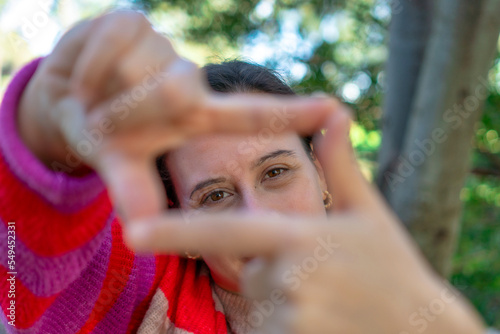 close-up of woman with fingers in square shape