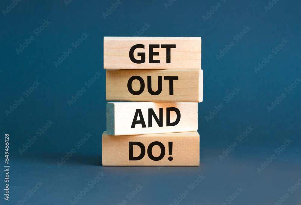 Motivational get out and do symbol. Concept words Get out and do on wooden cubes. Beautiful grey table grey background. Business motivational get out and do concept. Copy space. Motivational get out and do symbol. Concept words Get out and do on wooden cubes. Beautiful grey table grey background. Business motivational get out and do concept. Copy space.