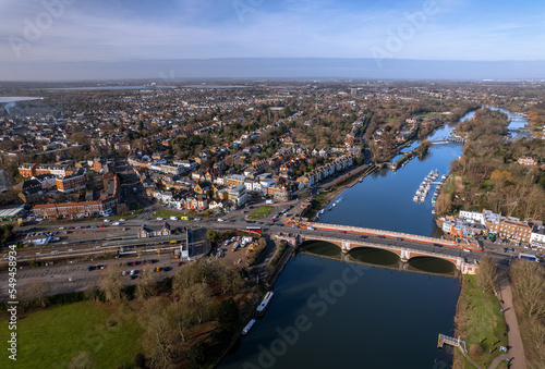 The drone aerial view of Hampton Court bridge and Thames river. Hampton Court Bridge crosses the River Thames in England between Hampton, London and East Molesey, Surrey.