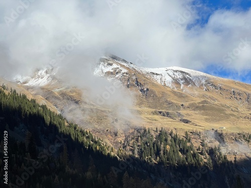 Mystical low autumn clouds and typical mountain fog in Swiss alpine area over the Calfeisental valley, Vättis - Canton of St. Gallen, Switzerland (Kanton St. Gallen, Schweiz) photo