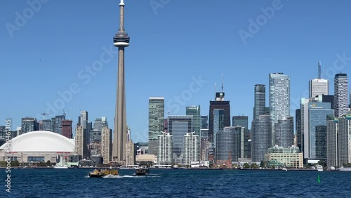 Toronto, Ontario, Canada - Oct. 2022 - video view of Toronto downtown with Skyline and the CN Tower with hight of 553.3 meters - boats crossing the Lake to Toronto Island