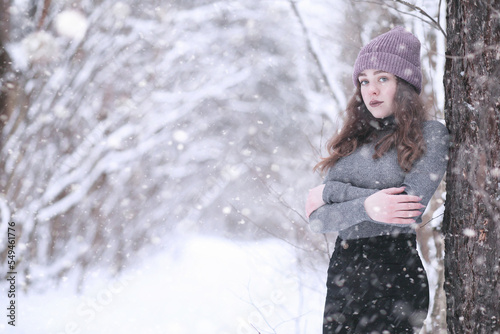 Girl in a winter park in snowfall
