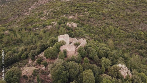 Aerial view circling around the ruins of Castellu di Seravalle, a military fortress built in the 11th century on a hilltop near the village of Popolasca in Corsica photo