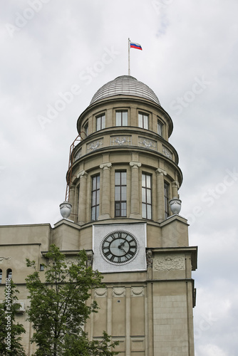 Moscow, Russia, сlock tower of the complex of buildings of the Northern Insurance Company on Ilinka, with the Russian flag and dial on the background of the sky photo