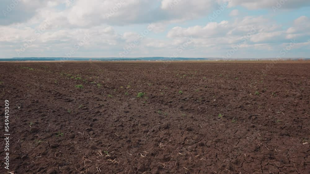 Agricultural landscape arable field. business agriculture concept. walk on brown black soil arable a land. preparation for sowing crops in sky agriculture landscape motion steadicam. farming field Agricultural landscape arable field. business agriculture concept. walk on brown black soil arable a land. preparation for sowing crops in sky agriculture landscape motion steadicam. farming field
