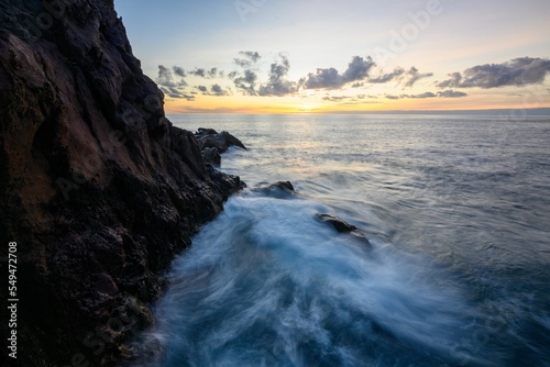 Beautiful shot of sea waves on the coastline of Madeira in Portugal during sunset photo