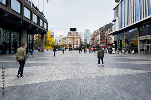 Pedestrians walking in a public square in Brussels photo