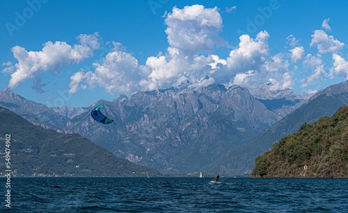 Beautiful shot of people kite surfing on the Como lake with mountains in the background