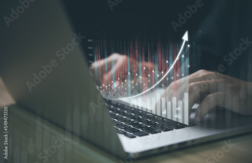 Businessman using a laptop to plan stock market analysis strategy with graphs chart 