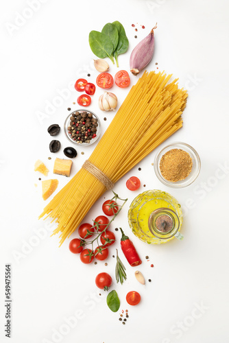 Set of healthy food ingredients isolated on white background, raw fettuccine pasta, cherry tomatoes, parmesan
