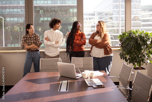 A group of  young colleagues are talking during a break in the office