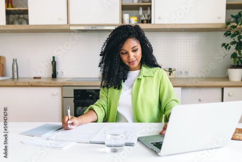Εκτύπωση καμβά Portrait of adorable african american woman translator working at kitchen table,