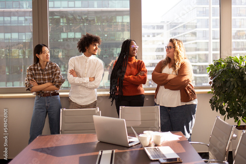 A group of young colleagues in the office are taking a break together