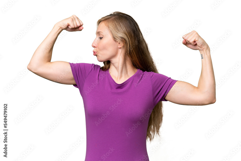 Young blonde woman over isolated background doing strong gesture Young blonde woman over isolated background doing strong gesture