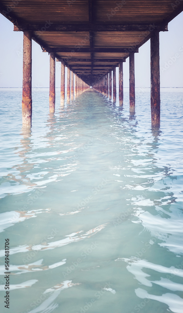 Under a wooden pier, retro color toning applied.