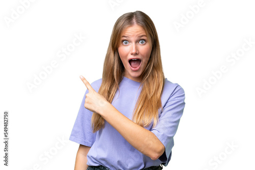 Young beautiful woman over isolated background surprised and pointing side