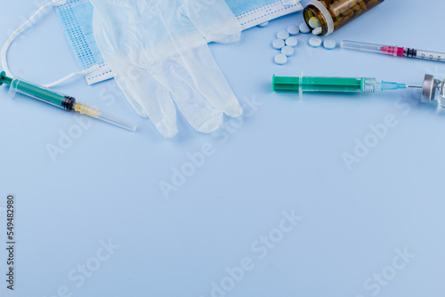 white medical protective glove, medical mask, syringe with needle, vaccination, vial and pills. illegal doping in sport concept ,flu vaccine, drug a addicted, wet medical. medical item background
